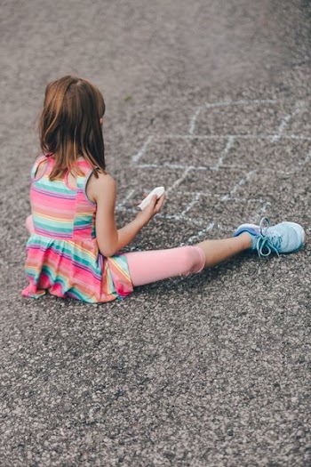 Young Girl Drawing Hopscotch