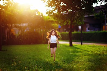 Young girl jump on grass