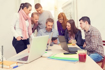 Young group of people discussing business plans.