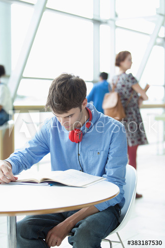 Young male college student studying at table