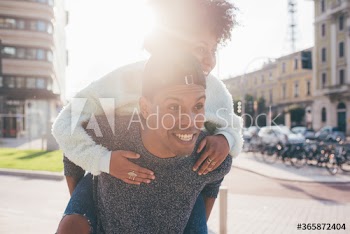 Young man giving piggyback ride to his girlfriend