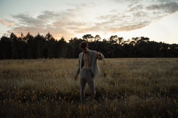 Young Man in Gray Jacket on Field