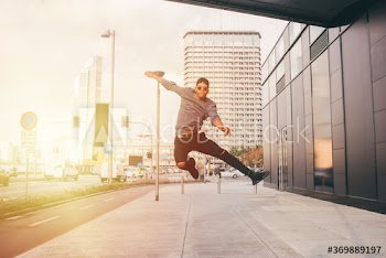 Young man jumping mid air on street