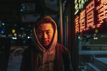 Young Man Stood In Front Of Light