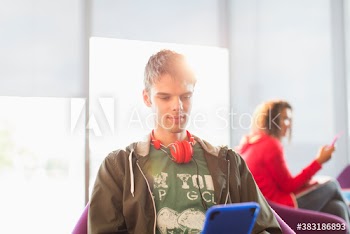 Young man with headphones using digital tablet