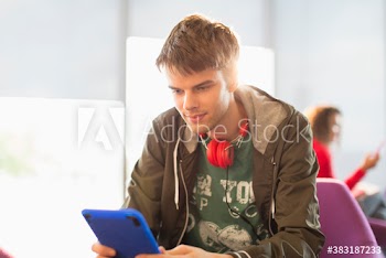 Young man with headphones using digital tablet