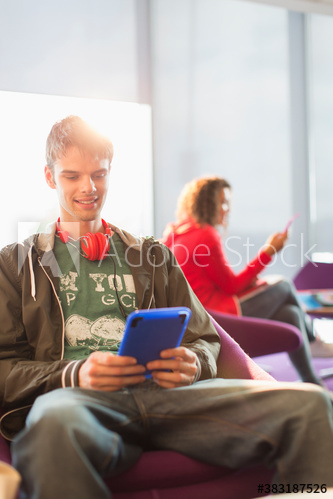 Young man with headphones using digital tablet
