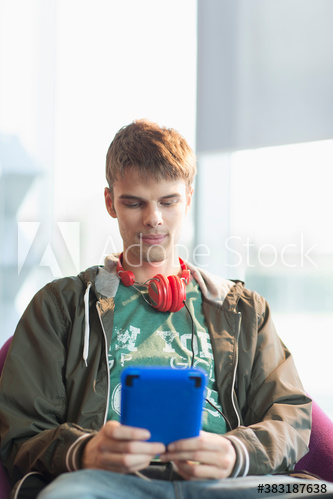 Young man with headphones using digital tablet