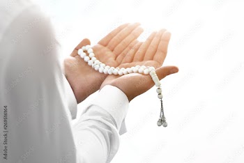 Young Muslim man praying indoors