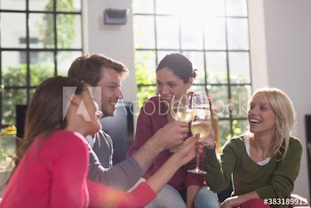 Young roommate friends toasting white wine glasses