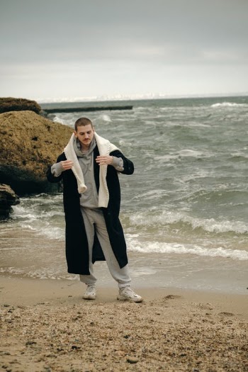 Young Short-hair Man in Sportswear Wearing Long Warm Coat and Posing at Seashore · Free Stock Photo