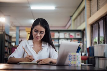 Young students learning, library bookshelves Free Photo