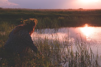Young woman by the pond