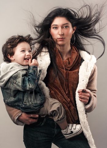 Young woman cradling boy