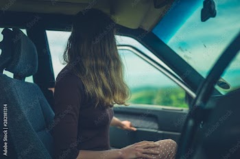 Young woman getting into her car