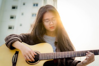 Young Woman Holding Guitar