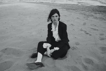 Young Woman in Formal Outfit Sitting on Beach · Free Stock Photo