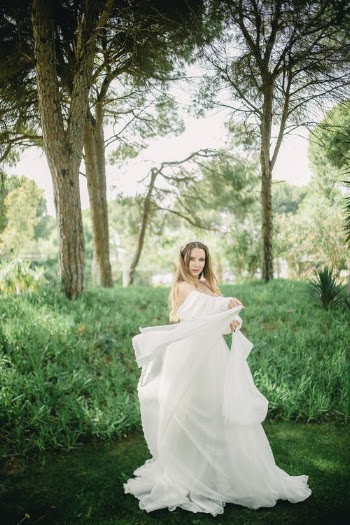 Young Woman in Park Presenting White Wedding Dress  · Free Stock Photo