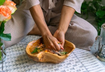 Young woman intentionally making flower infused herbal bath