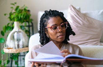 Young woman journaling in her home