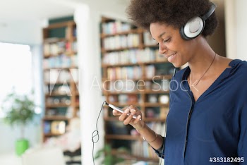 Young woman listening to music with headphones and mp3 player