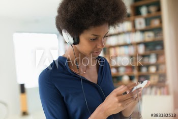 Young woman listening to music with headphones and smart phone