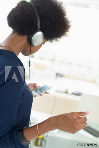 Young woman listening to music with headphones and smart phone