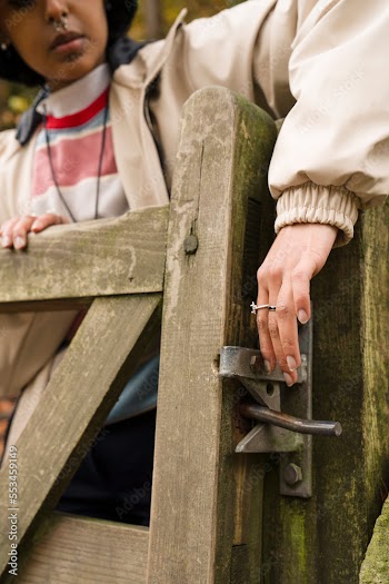 Young woman opening gate while hiking