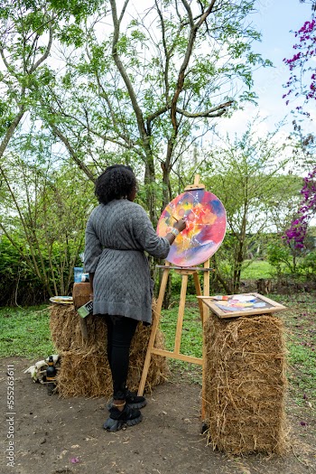 young woman painting outdoors on a cloudy day
