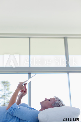 Young woman relaxing with digital tablet