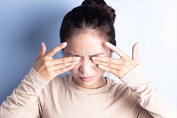 Young woman rubbing her eyes