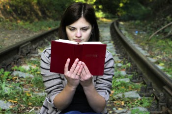 Young Woman Sitting on Bench in Park