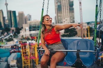 Young Woman Smiling On Swing Ride