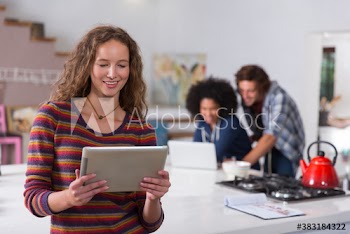 Young woman using digital tablet in apartment kitchen