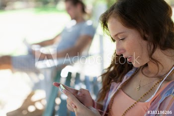 Young woman using smart phone in park