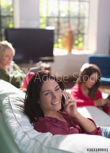 Young woman using smart phone on sofa