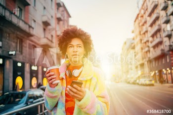 Young woman using smartphone on street