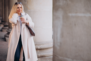 Young woman wear trench-coat and glasses