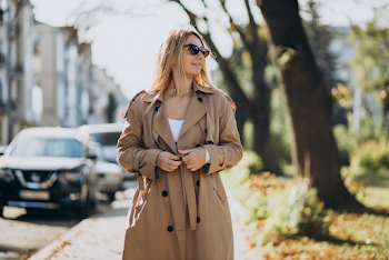 Young woman wear trench-coat and glasses