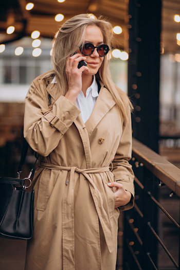 Young woman wear trench-coat and glasses