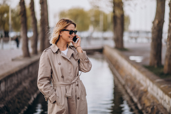 Young woman wear trench-coat and glasses