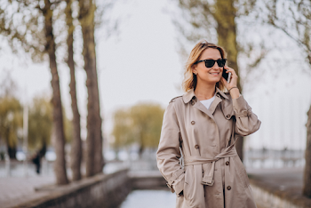 Young woman wear trench-coat and glasses