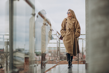 Young woman wear trench-coat and glasses