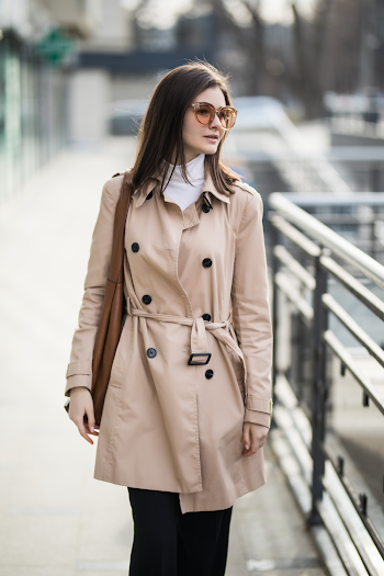 Young woman wear trench-coat and glasses