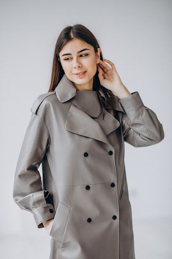Young woman wearing a leather trench-coat