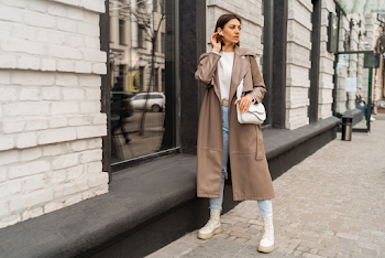 Young woman wearing a leather trench-coat