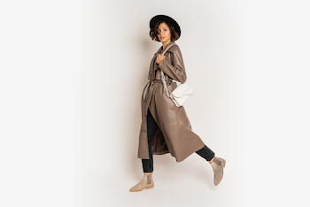 Young woman wearing a leather trench-coat