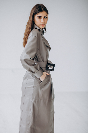 Young woman wearing a leather trench-coat