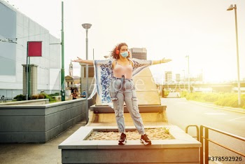 Young woman wearing medical mask standing on street