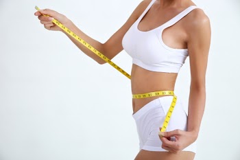 Young woman with beautiful body and measure tape Free Photo